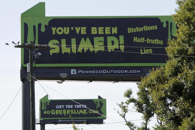 These are billboards along the Pennsylvania Turnpike in New Stanton, Pa., that attack critics of natural gas on Tuesday, Sept. 11, 2012. The website describes critics of gas drilling as "green slime."