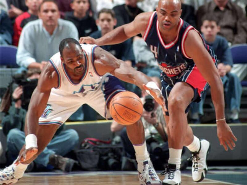 04.01.99 - Jazz forward karl malone loses the ball after it is knocked away by Rockets defender Charles Barkley. Photo by Gary McKellar.