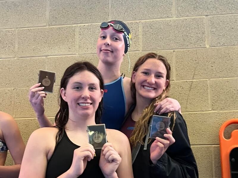 Skyline’s Jade Garstang, top, receives her Region 6 first-place medal after breaking the 100 butterfly overall state record on Friday at the South Davis Rec Center. Also pictured is Highland’s Ellinor Plant, left, and Highland’s Veronica Black.