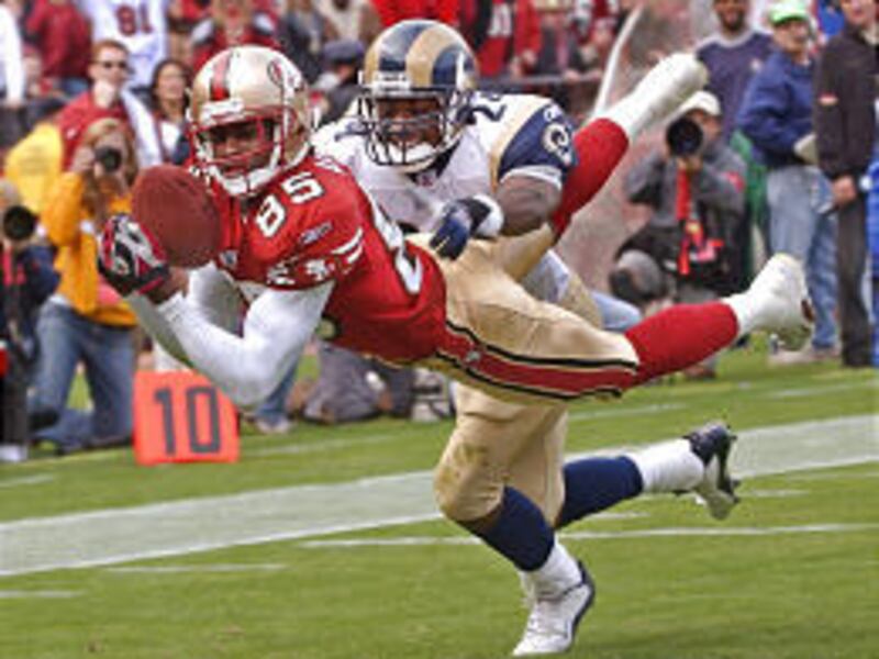 San Francisco wide receiver Brandon Lloyd (85) dives for a touchdown catch in front of St. Louis defender DaeJuan Groce during the Niners' win Sunday.