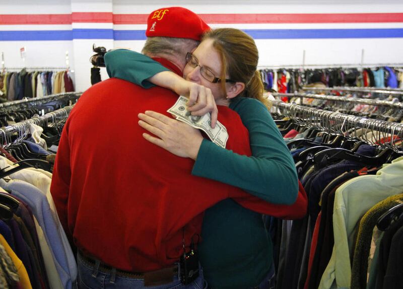 Janice Kennedy hugs Secret Santa after getting a $100 dollar bill from the wealthy philanthropist from Kansas City, Mo. while looking for clothes at the Salvation Army store in the boro of Staten Island, New York, N.Y., Thursday, Nov. 29, 2012. Secret San
