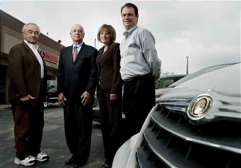 Phidia Cutrubus, left, Homer Cutrubus, Chris Sorensen and H. Kord Cutrubus in front of their Layton dealership.