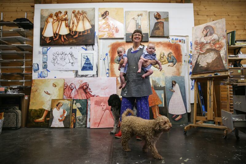 Caitlin Connolly poses for photos with her twin sons and dogs at her home art studio in Provo on Thursday, April 12, 2018.