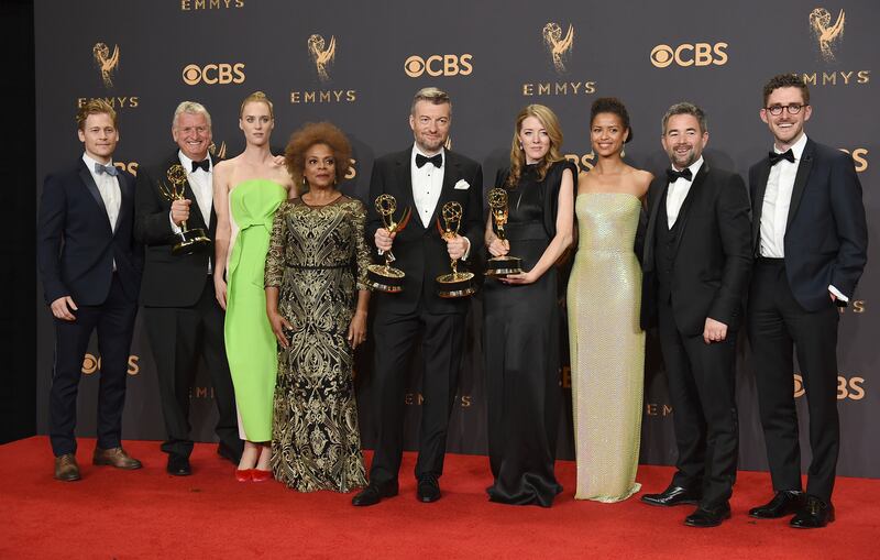 The cast and crew of "Black Mirror: San Junipero" pose in the press room with their awards for for outstanding television movie at the 69th Primetime Emmy Awards on Sunday, Sept. 17, 2017, at the Microsoft Theater in Los Angeles.
