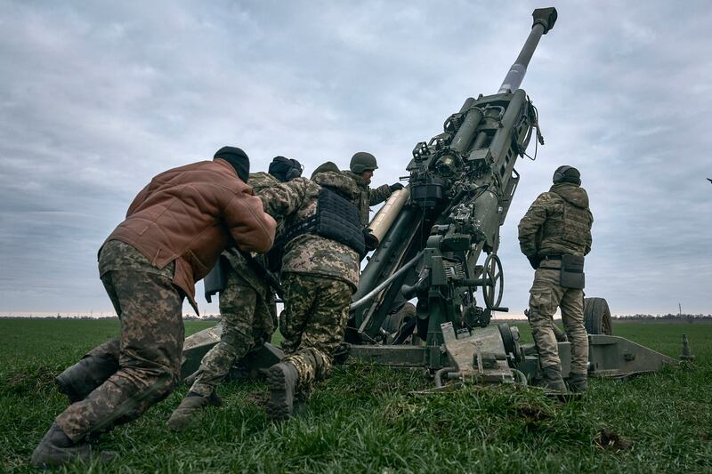 Ukrainian soldiers prepare a U.S.-supplied M777 howitzer to fire at Russian positions in Kherson region, Ukraine.