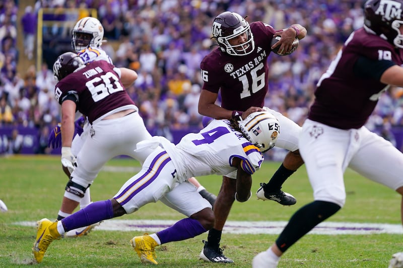 FILE - Texas A&M quarterback Jaylen Henderson (16) is tackled by LSU linebacker Harold Perkins Jr. (4) during game in Baton Rouge, La., Saturday, Nov. 25, 2023. The Aggie transfer is expected to be under center for West Virginia when the Utes pay Morgantown a visit Saturday.