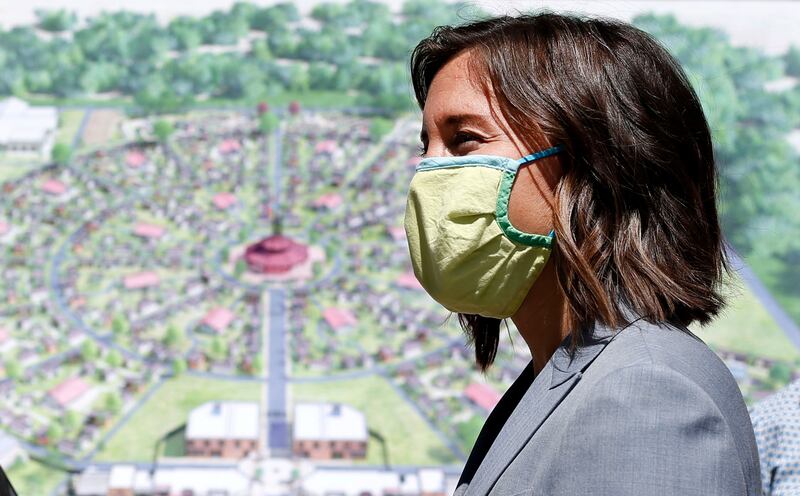 Salt Lake City Mayor Erin Mendenhall stands in front of a conceptual drawing for The Other Side Village.