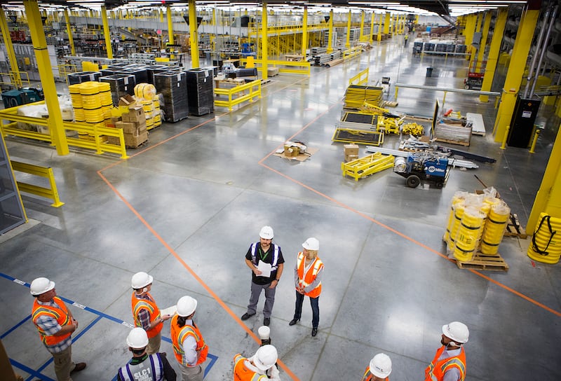 Michael Taylor, general manager of Amazon's new Utah fulfillment center, and Salt Lake City Mayor Jackie Biskupski stand before members of the media during a tour of the new facility in Salt Lake City on Monday, Aug. 13, 2018. The 855,000-square-foot faci