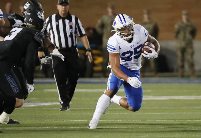 Brigham Young Cougars running back Tyler Allgeier runs against Utah State.