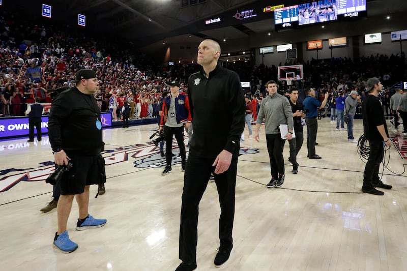 BYU coach Mark Pope, center, walks on the court after a game against Gonzaga, Saturday, Feb. 11, 2023, in Spokane, Wash.