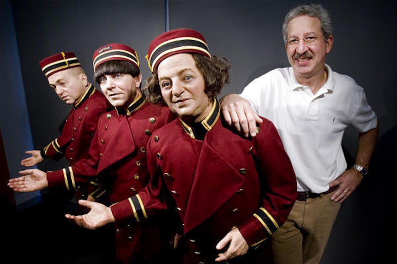 Gary Lassin poses for a picture with life-size replicas of the Three Stooges at the Stoogeum in Spring House, Pa., last summer.