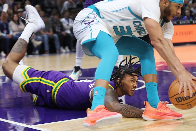Utah Jazz forward Brice Sensabaugh (8) competes for the loose ball with Charlotte Hornets guard Seth Curry (30) in Salt Lake City on Thursday, Feb. 22, 2024.