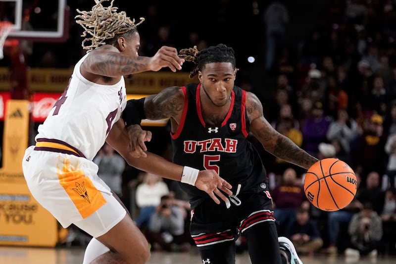 Utah’s Deion Smith (5) drives past Arizona State’s Adam Miller (44) during the first half of an NCAA college basketball game Thursday, Jan. 4, 2024, in Tempe, Ariz.