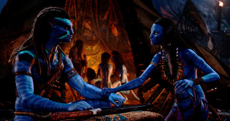 Jake Sully, performed by Sam Worthington, left, and Neytiri, performed by Zoe Saldana in a scene from “Avatar: The Way of Water.”