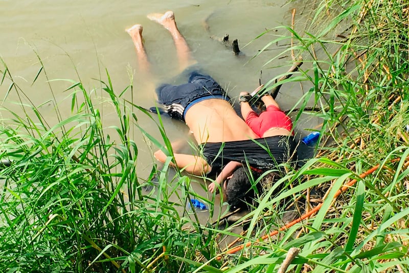 The bodies of Salvadoran migrant Oscar Alberto Martínez Ramírez and his nearly 2-year-old daughter Valeria lie on the bank of the Rio Grande in Matamoros, Mexico, Monday, June 24, 2019, after they drowned trying to cross the river to Brownsville, Texas. M