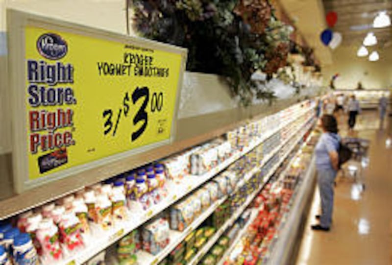 A shopper checks out dairy foods at a Kroger in Cincinnati. Kroger’s first-quarter profit rose 4 percent.