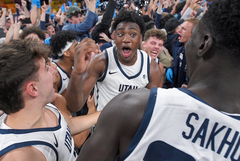 Utah State forward Great Osobor, center, celebrates with players and fans after the team’s win over Colorado State in an NCAA college basketball game Saturday, Jan. 6, 2024, in Logan, Utah. (Eli Lucero/The Herald Journal via AP)