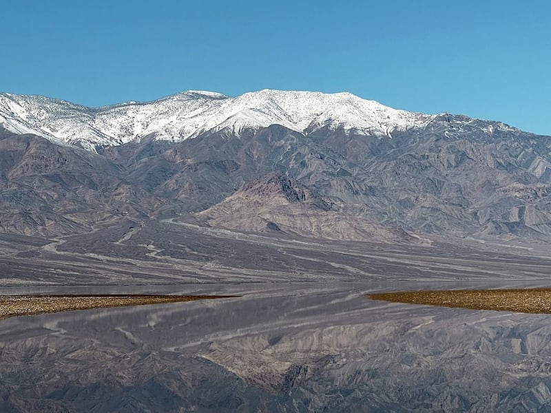 In this photo released by the National Park Service, is a lake created at Badwater Basin in Death Valley National Park, Calif.