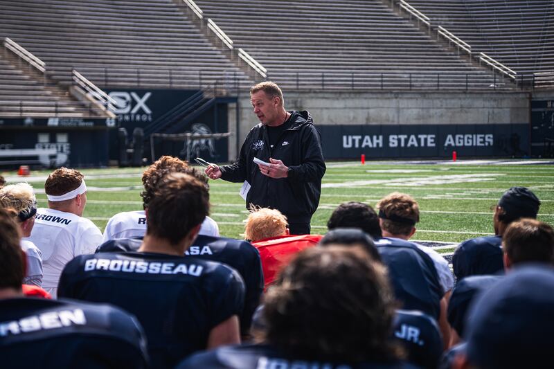 First-year Utah State football coach Bronco Mendenhall talks to his players during spring football practice at Maverik Stadium in Logan, Utah.
