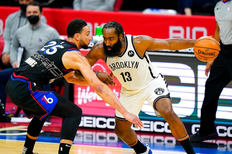 Brooklyn Nets’ James Harden tries to drive past Philadelphia 76ers’ Ben Simmons.