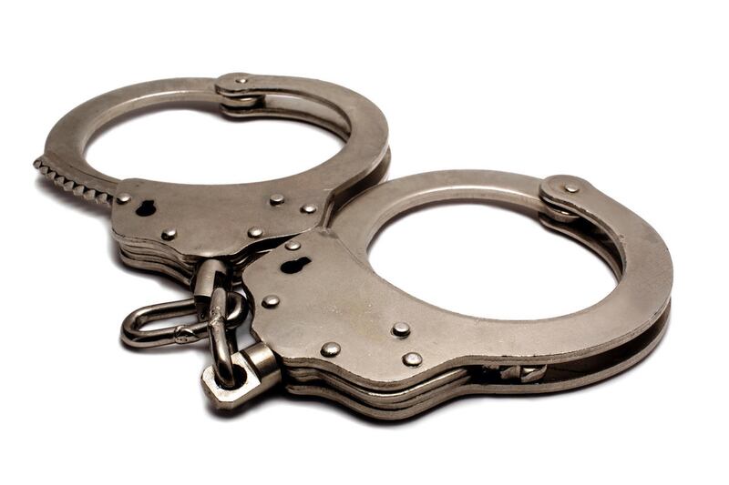 police handcuffs lying on a white background