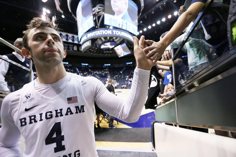 Brigham Young Cougars guard Nick Emery (4) gives high fives to fans after the game as BYU falls to the University of Texas at Arlington play in NIT basketball action at the Marriott Center in Provo Utah on Wednesday, March 15, 2017.