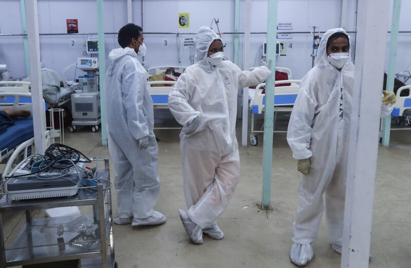 Health workers keep a watch on patients in a ward at the BKC jumbo field hospital, one of the largest COVID-19 facilities in Mumbai, India.