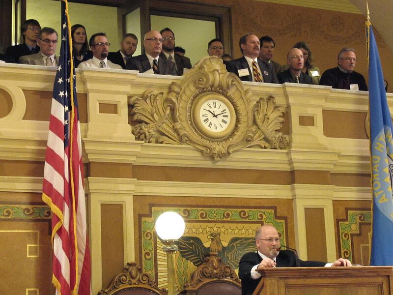 House Speaker Val Rausch, R-Big Stone City, lower right, presides over the South Dakota House of Representatives on Monday, March 28, 2011, in Pierre, S.D., as a group of chiropractors watches from the gallery above. The chiropractors successfully lobbied
