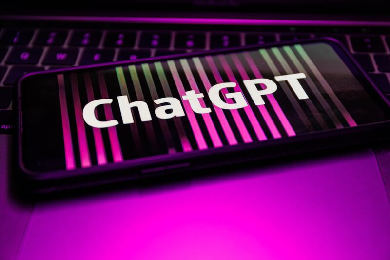The logo of ChatGPT is displayed on a phone screen.