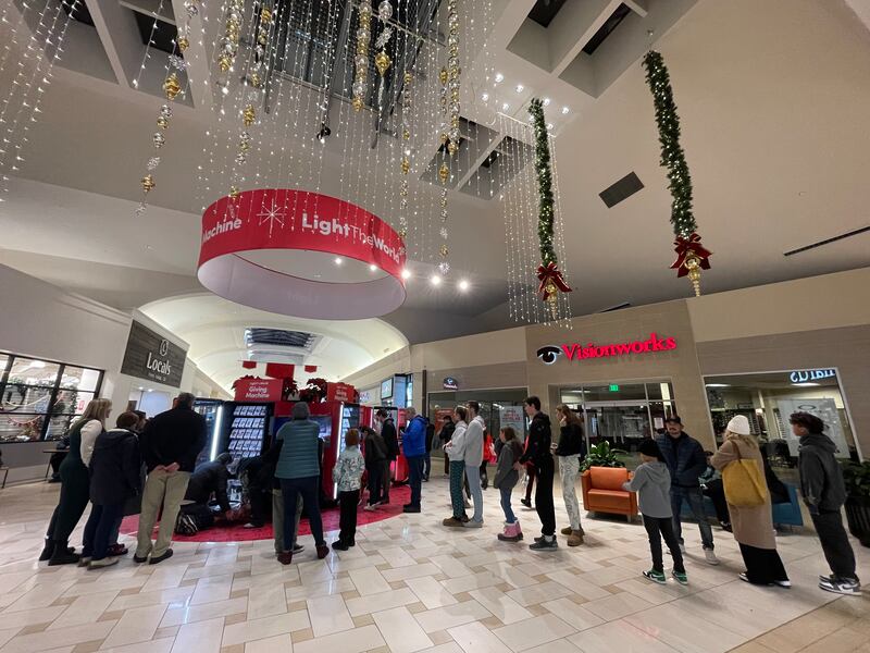 Crowds line up to make donations at the Light the World Giving Machines at University Place in Orem, Utah, on Dec. 23, 2023.