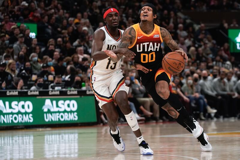 Jazz guard Jordan Clarkson goes past New Orleans’ Kira Lewis Jr. during game in Salt Lake City on Saturday, Nov. 27, 2021.