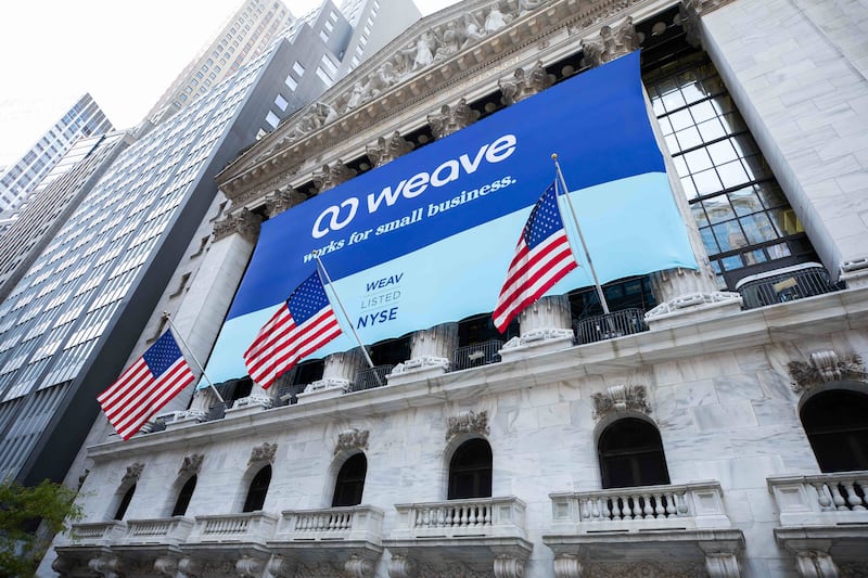 A banner for Utah tech company Weave hangs outside of the New York Stock Exchange.