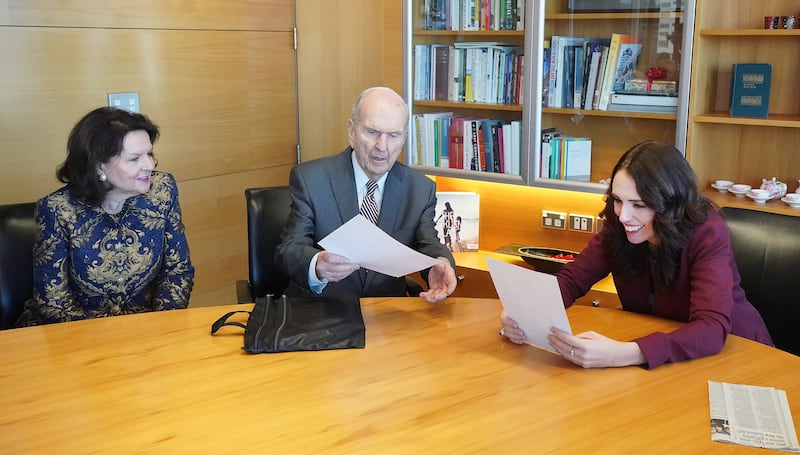 President Russell M. Nelson of The Church of Jesus Christ of Latter-day Saints and his wife, Sister Wendy Nelson, give photos of the First Presidency and Quorum of the Twelve Apostles to New Zealand Prime Minister Jacinda Ardern in Wellington, New Zealand