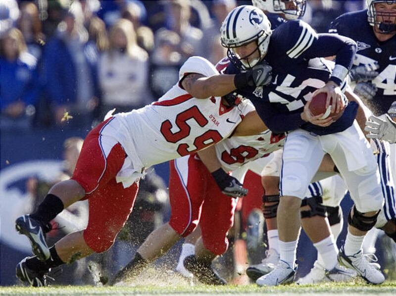 BYU quarterback "Die Hard" Max Hall is dragged down by Utah's Kepa Gaison in the Cougars' 17-10 win last Saturday in Provo.