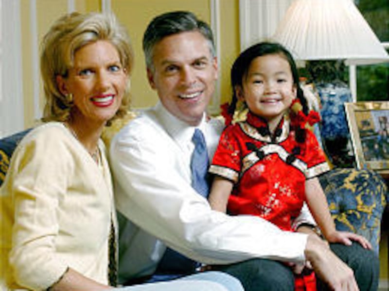 First lady Mary Kaye and Gov. Jon Huntsman Jr. sit with Gracie Mei, adopted from China. A child from India will join Gracie and her five siblings.