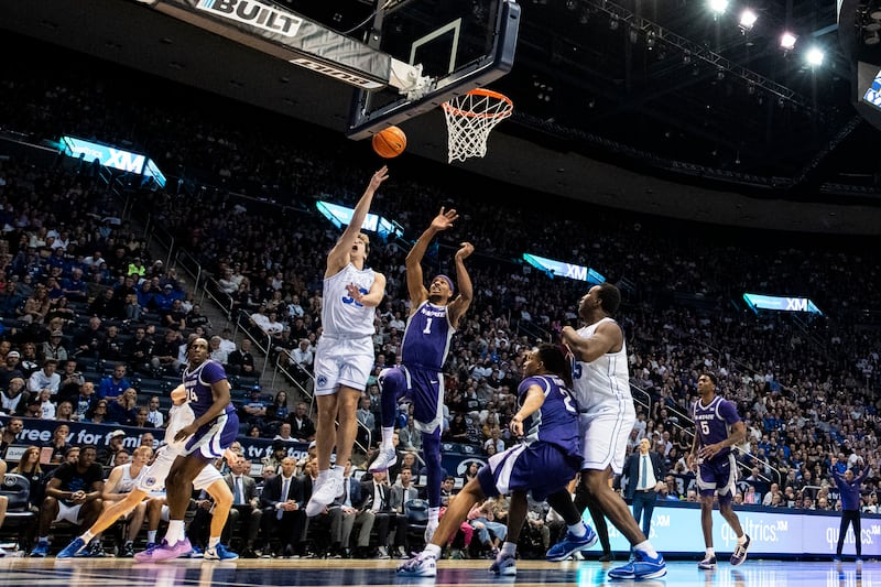 BYU guard Dallin Hall, center left, lays the ball up past Kansas State forward David N’Guessan in Provo, Utah.