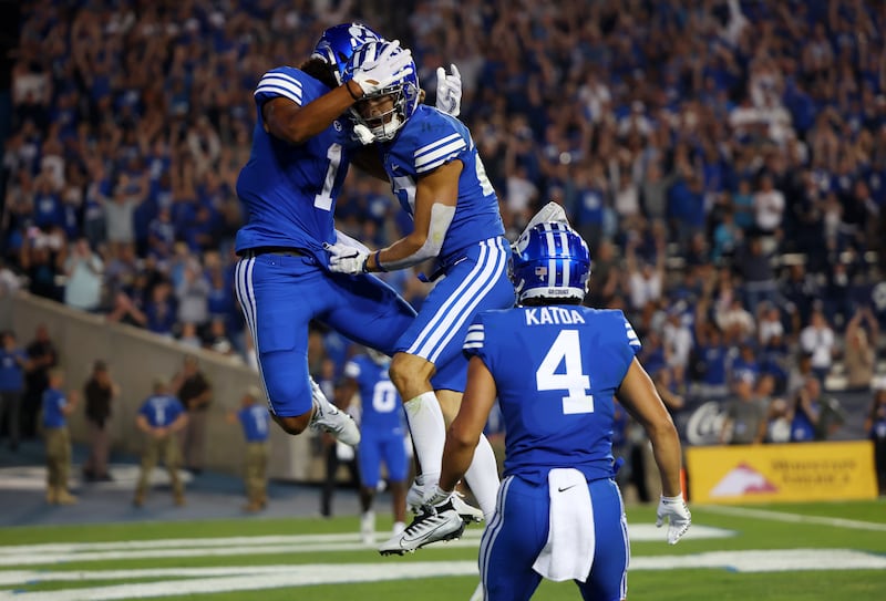 BYU receivers Keanu Hill (1) and Chase Roberts jump into the air after Roberts scored a touchdown against Baylor.