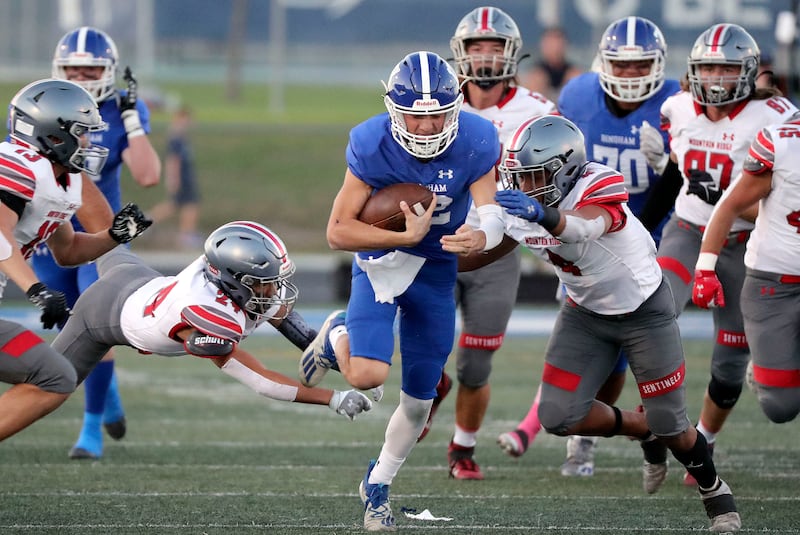 Bingham’s Dallen Martinez gets tackled by Mountain Ridge’s Chase Leiataua (24) and DeMarco Brimmage (4)