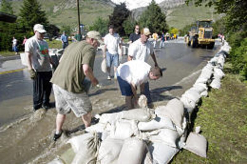 Sand bags are placed along 500 North in Pleasant Grove to manage the flooding.