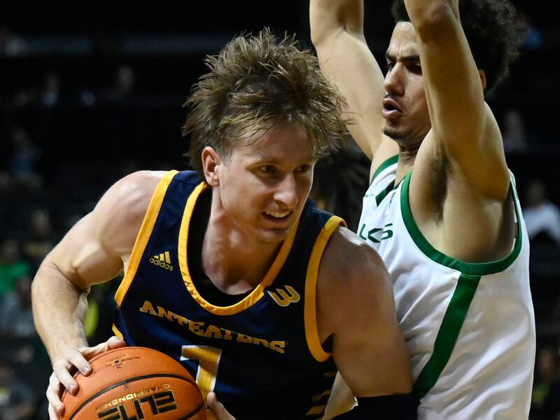 UC Irvine guard Dawson Baker, left, is guarded by Oregon guard Will Richardson during a game on Nov. 11, 2022.