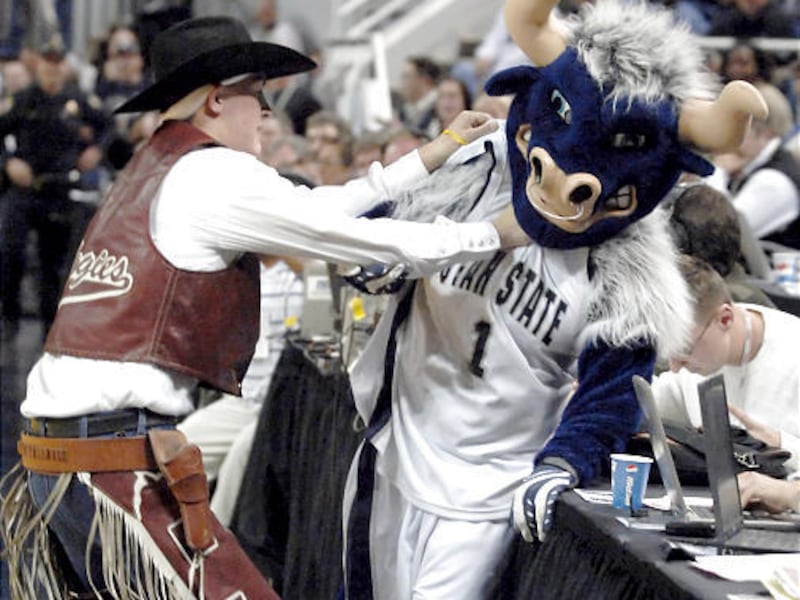 New Mexico State mascot Pistol Pete, left, chokes Utah State mascot Big Blue after his mustache was ripped off by Big Blue on Friday.