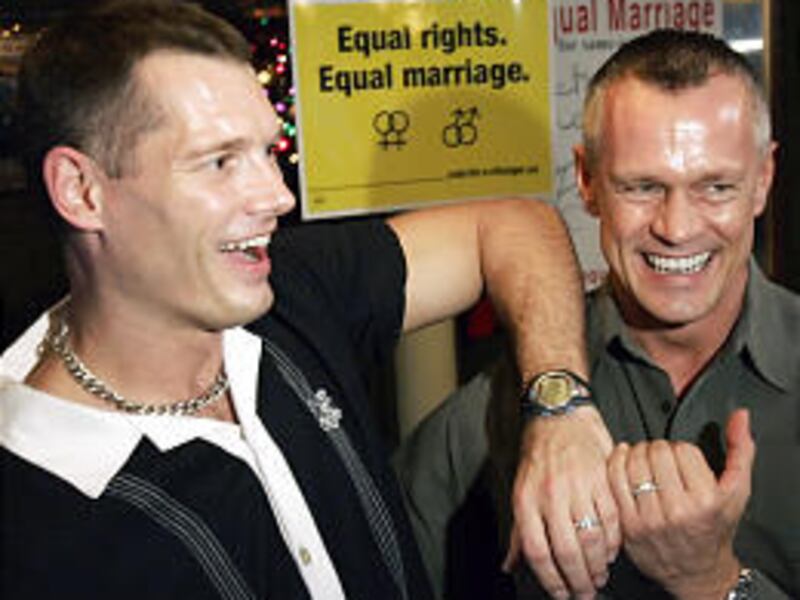 At a Toronto bar, Peter Rex, left, and Steve Martin show off their engagement rings during a celebration of the Canadian Supreme Court's opinion Thursday affirming the legality of same-sex marriage.