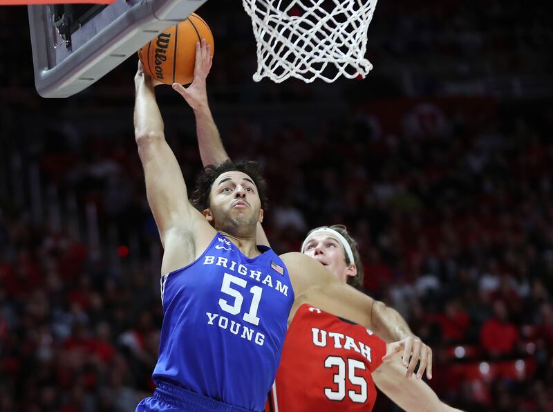 Brigham Young Cougars forward Gavin Baxter (51) has his shot blocked by Utah Utes center Branden Carlson (35).