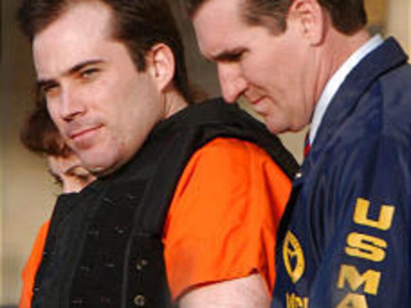 Eric Rudolph is led from a courthouse in Huntsville, Ala., in March. His deal includes guilty pleas to two deaths and more than 100 injuries caused by bombings.