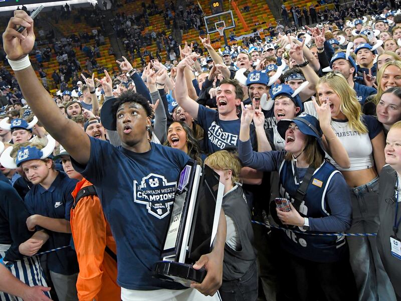 Utah State forward Great Osobor celebrates with fans after the team's win over New Mexico Saturday, March 9, 2024, in Logan, Utah.