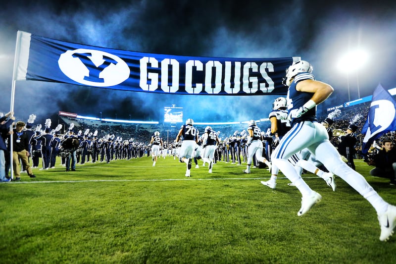 BYU players run onto the field as they and Hawaii prepare to play at LaVell Edwards Stadium in Provo on Oct. 13, 2018.