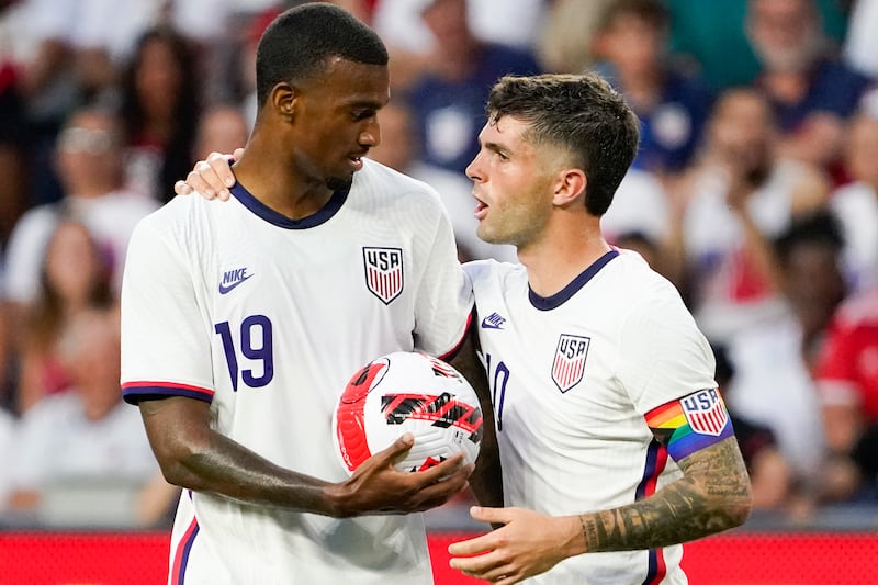 U.S. forward Christian Pulisic, right, hands the ball to Haji Wright (19) prior to a penalty kick.