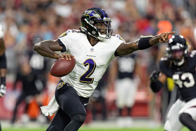 Quarterback Tyler Huntley of the Baltimore Ravens rolls out to pass against the Arizona Cardinals in an NFL preseason football game, Sunday, Aug. 21, 2022, in Glendale, Ariz. Ravens won 24-17.