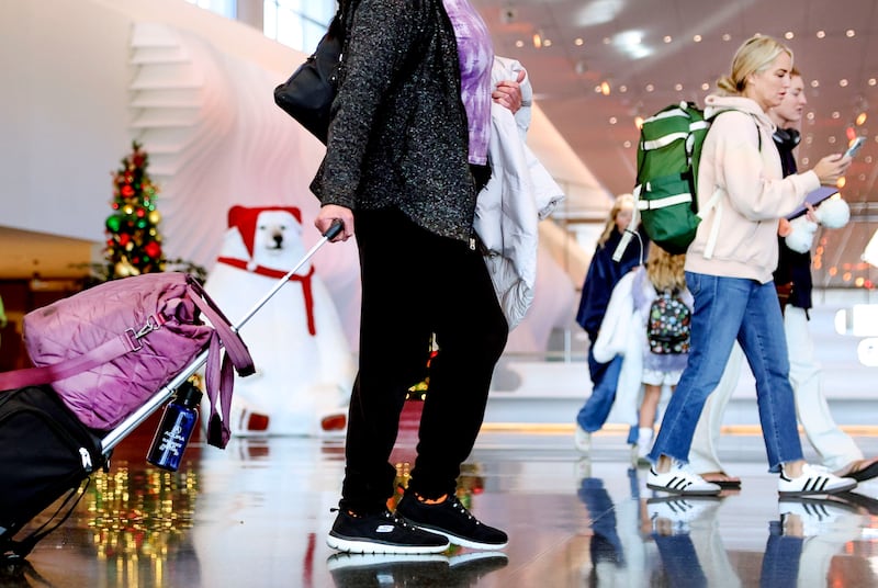 People walk through the Salt Lake City International Airport on Wednesday, Nov. 21, 2023.