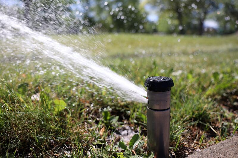 A sprinkler runs at Liberty Park in Salt Lake City on July 7, 2022.